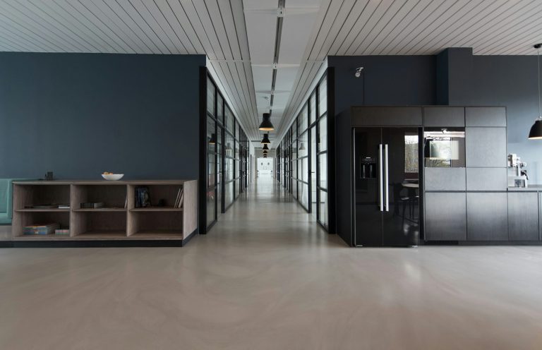 Moderner, heller Flur mit Glaswänden und minimalistischen Möbeln.